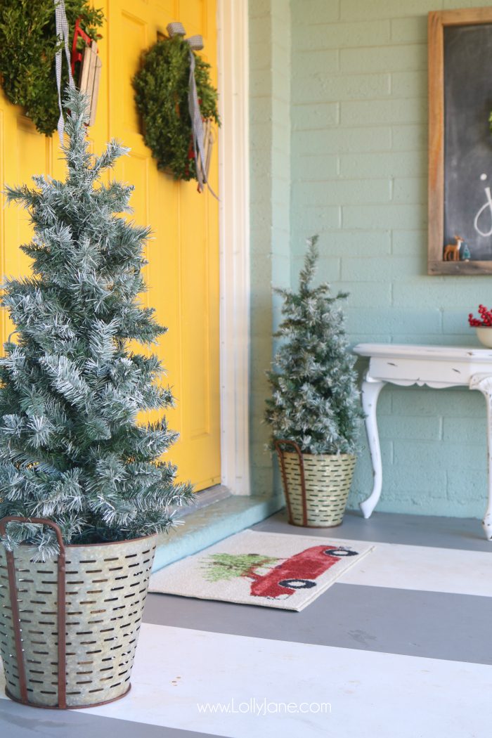 Farmhouse Christmas porch decor. Easy ways to bring a little farmhouse charm to the outdoors. Love the olive buckets and fresh boxwood wreaths.