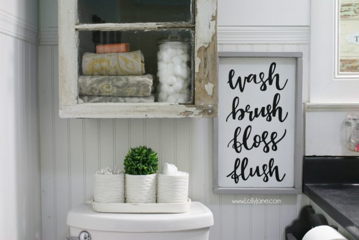 Such a pretty farmhouse bathroom! All DIY like this handmade cabinet. Please get me that sign!