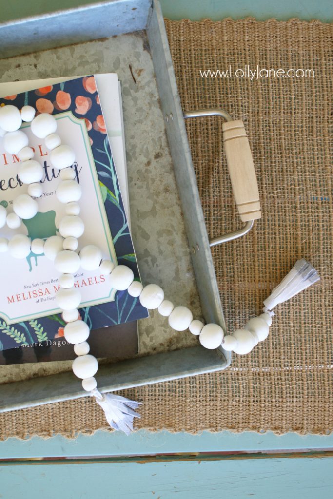 DIY How to make a wood bead garland. Jump on this hot home decor trend of wood beads! Accessorize your home decor with cute wood bead garlands and for less than $5! Love these diy wood bead garlands!