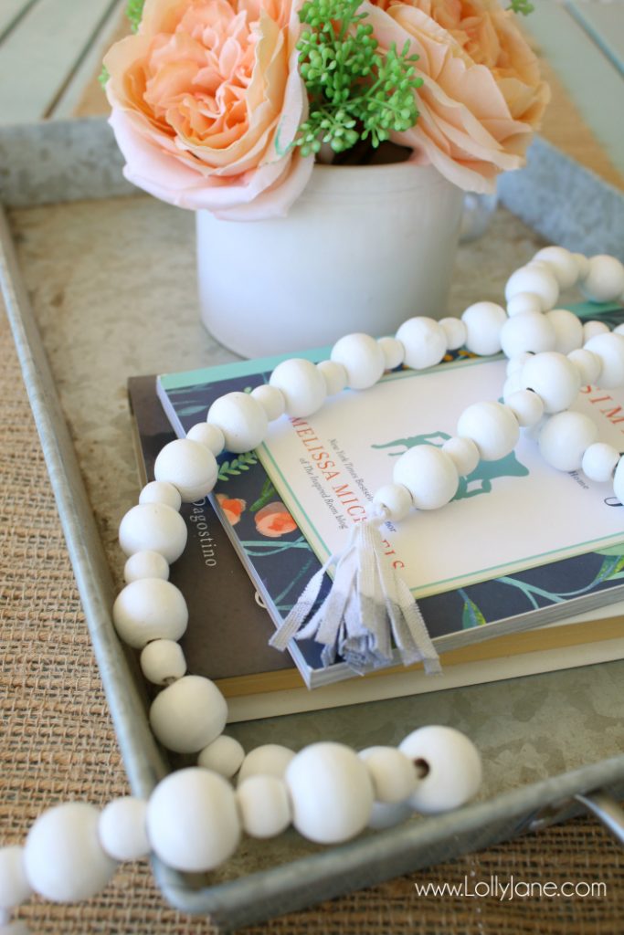 DIY How to make a wood bead garland. Jump on this hot home decor trend of wood beads! Accessorize your home decor with cute wood bead garlands and for less than $5! Love these diy wood bead garlands!