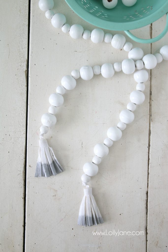 DIY How to make a wood bead garland. Jump on this hot home decor trend of wood beads! Accessorize your home decor with cute wood bead garlands and for less than $5! Love these diy wood bead garlands!