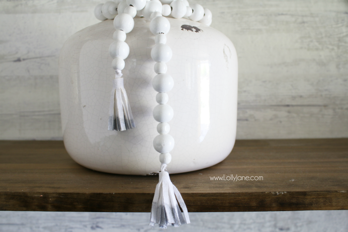 DIY How to make a wood bead garland. Jump on this hot home decor trend of wood beads! Accessorize your home decor with cute wood bead garlands and for less than $5! Love these diy wood bead garlands!