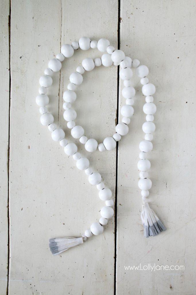 DIY How to make a wood bead garland. Jump on this hot home decor trend of wood beads! Accessorize your home decor with cute wood bead garlands and for less than $5! Love these diy wood bead garlands!