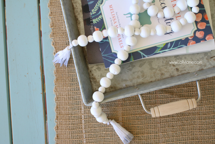 DIY How to make a wood bead garland. Jump on this hot home decor trend of wood beads! Accessorize your home decor with cute wood bead garlands and for less than $5! Love these diy wood bead garlands!