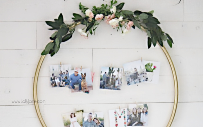 Looking for creative ways to display family pictures? This <strong>DIY Hula Hoop Photo Display</strong> is so easy to make. We love the gold accents and faux florals and you'll love how easy it was to put together. #hulahoophack #photodisplay #weddingidea #diyweddingphoto #photodisplayideas