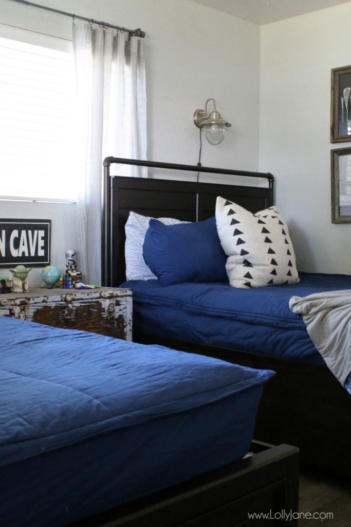 Looking for space saving tips for a shared bedroom? Love these ways to organize a boys room with cute matching bedding too!