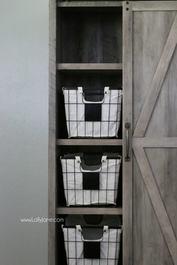 Love this farmhouse cabinet with these chalkboard wire baskets. Such cute laundry room decor!