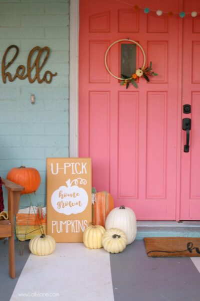 Cute "U-Pick Pumpkins" sign, perfect touch to this colorful farmhouse fall porch!