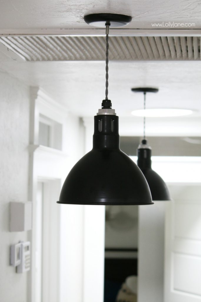 Love these black barn light pendants in this farmhouse makeover. Such a pretty farmhouse hallyway!