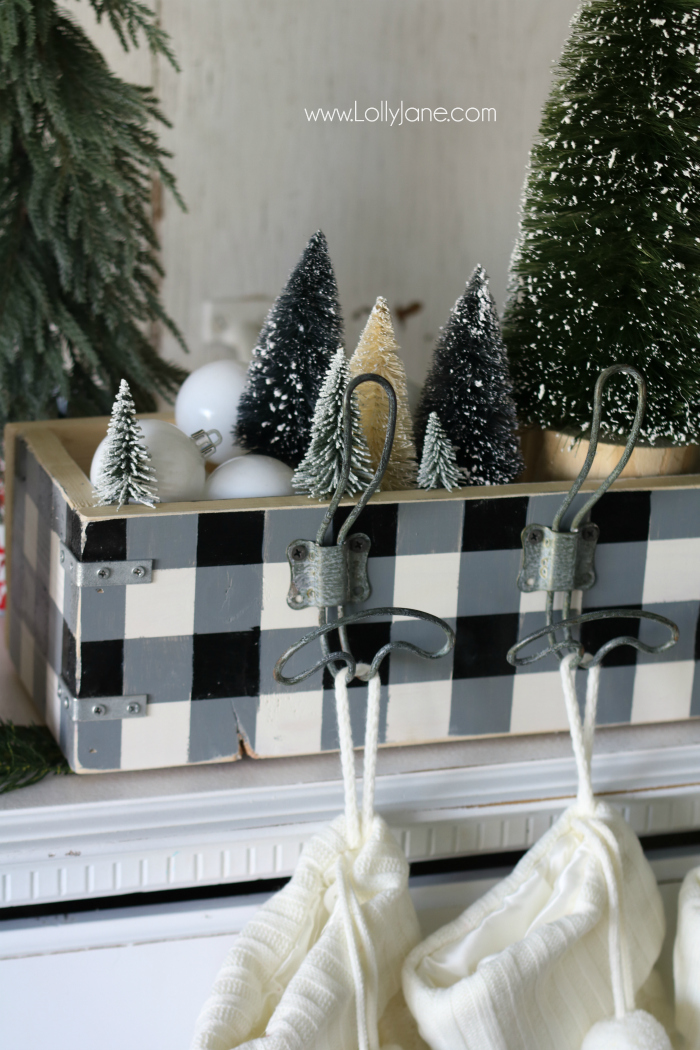 Love this farmhouse Christmas decor using bottle brush trees and buffalo check, love this easy wood stocking hanger too!