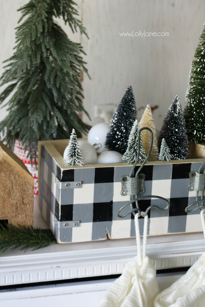 Spruce up your Christmas decor by making a stocking hanger! It displays your stockings and houses cute Christmas decor too like bottle brush trees and white ornaments!