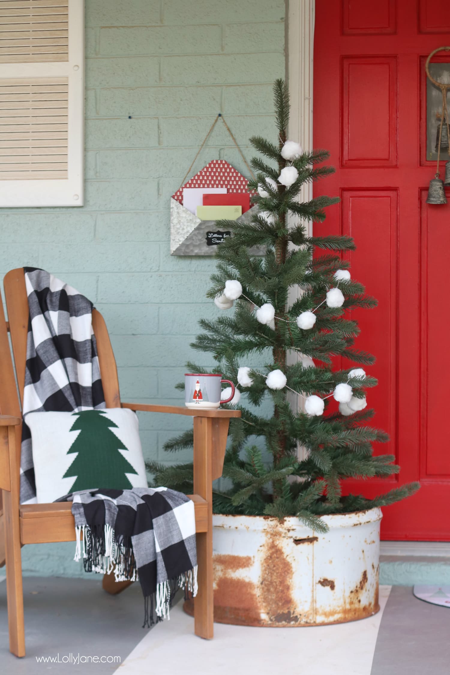 Cutest porch ever! The buffalo check throw with the EASY diy pom pom garland is such a cute combo, make your porch pop in less than 20 minutes and for less than $10! SO cute!