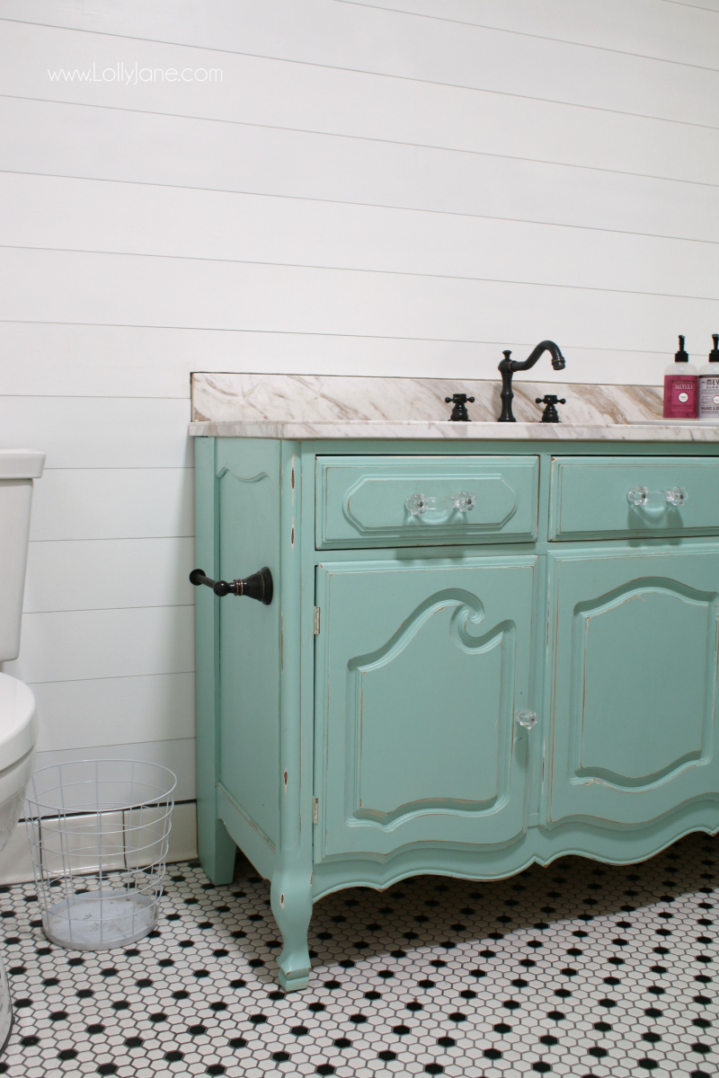 Loving this fun colored aqua vanity from a dresser! Classic shilap that's easy to apply makes this bathroom remodel a breeze!