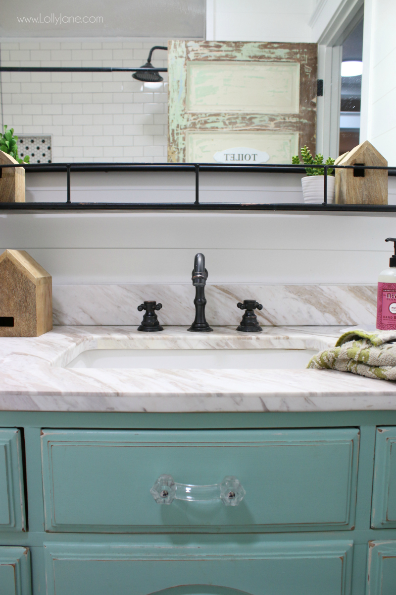 Modern farmhouse bathroom decor. Love this oil rubbed bronze sink with a marble vanity top and aqua dresser turned vanity. Love this farmhouse bathroom remodel!