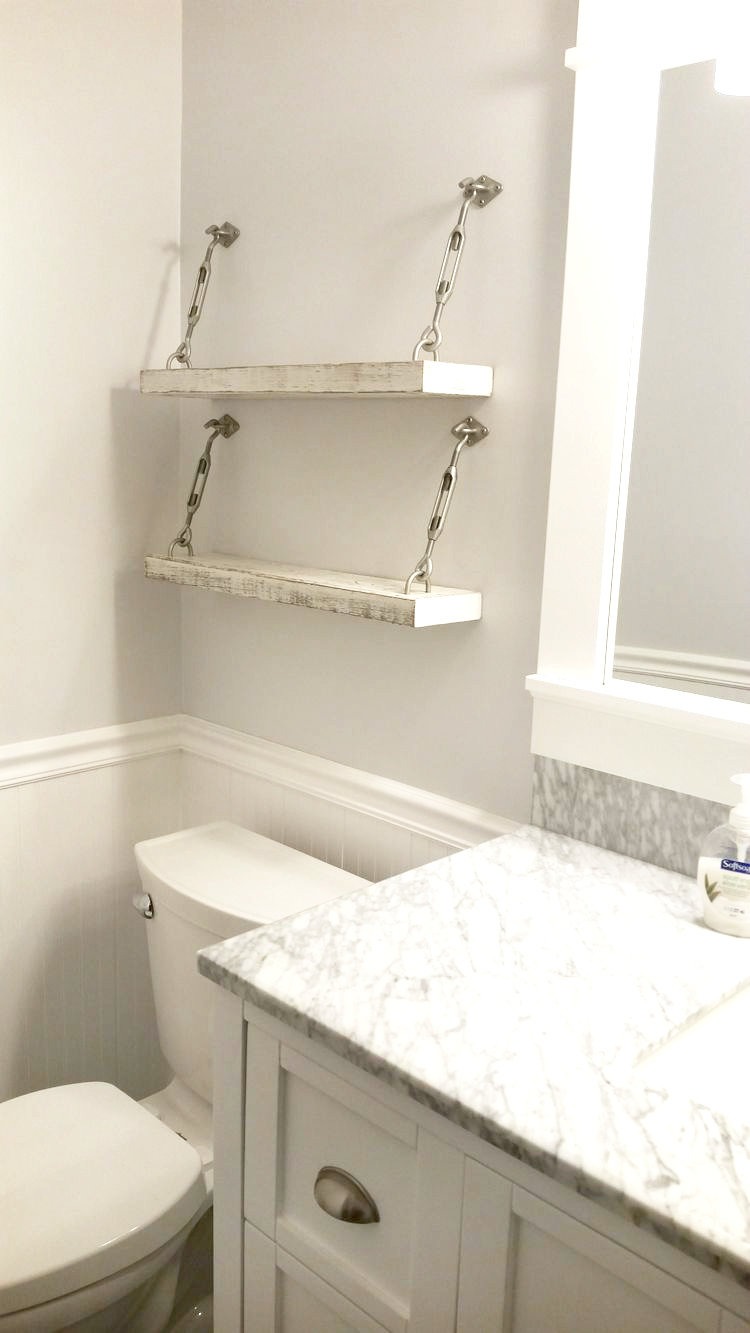 Easy to make white painted turnbuckle shelf bathroom decor. Love this white wood turnbuckle shelf with silver turnbuckles. Such an easy way to provide storage for your bathroom! #modernbathroom #modernfarmhouse #turnbuckle #turnbuckleshelf