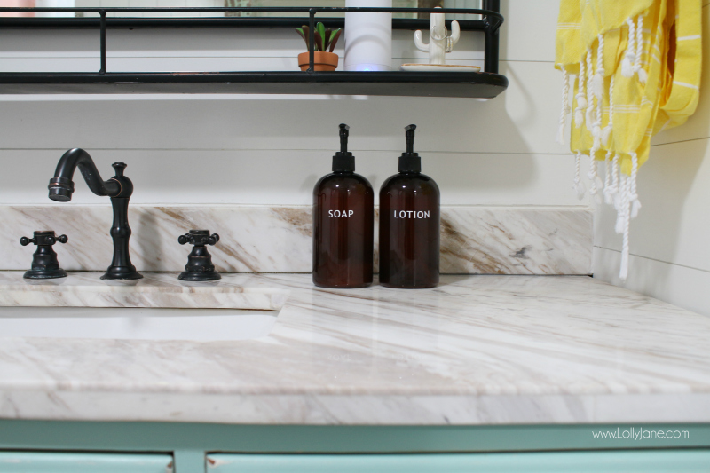 Loving this farmhouse bathroom renovation. These amber bottles are the perfect bathroom accessory to style soap and lotion.