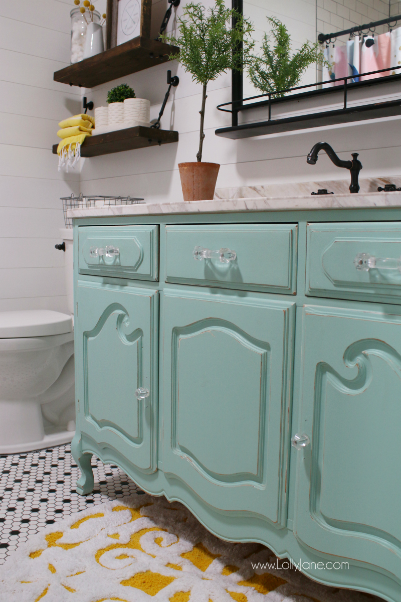 Loving this aqua vanity bathroom decor. This old dresser painted with a new marble top makes a great custom farmhouse bathroom vanity!