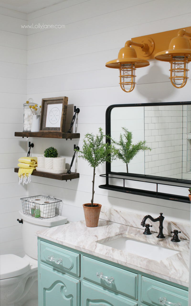 Loving this aqua vanity farmhouse bathroom decor with the mustard yellow barn lights and pharmacy mirror!