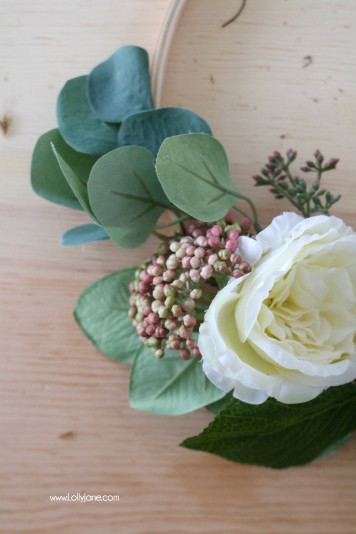 Gorgeous faux florals on this easy DIY spring embroidery hoop wreath really POP! So simple to make in a flash!