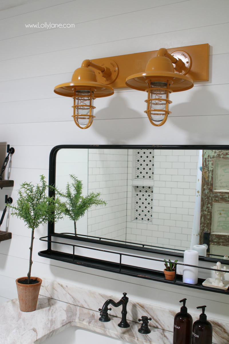 So in love with this mustard yellow bathroom light decor! A vintage bathroom light is the perfect accessory to this bathroom renovation.