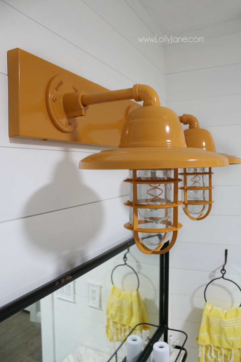 farmhouse bathroom vanity lights - So in love with this yellow barn light bathroom decor in this farmhouse renovation. 