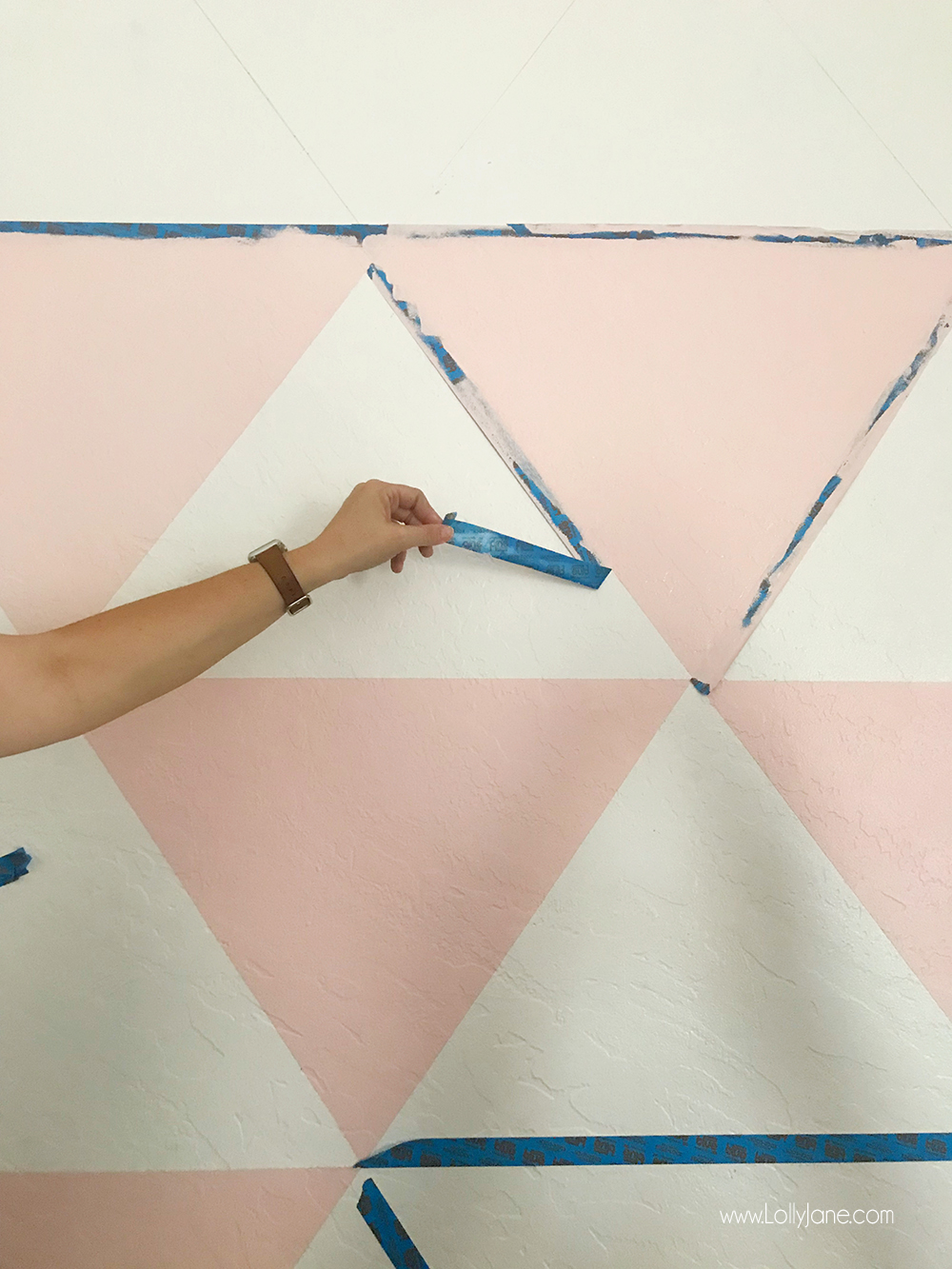 Love this DIY Triangle Accent Wall! It was so easy to create... a little painters tape and Behr paint make the perfect combo to spruce up this space!