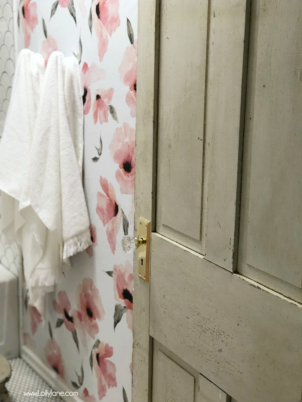 The vintage door (and glass knob!) is the cherry on top to this fully renovated girls glam farmhouse bathroom. Gorgeous! Love those floral wallpaper!