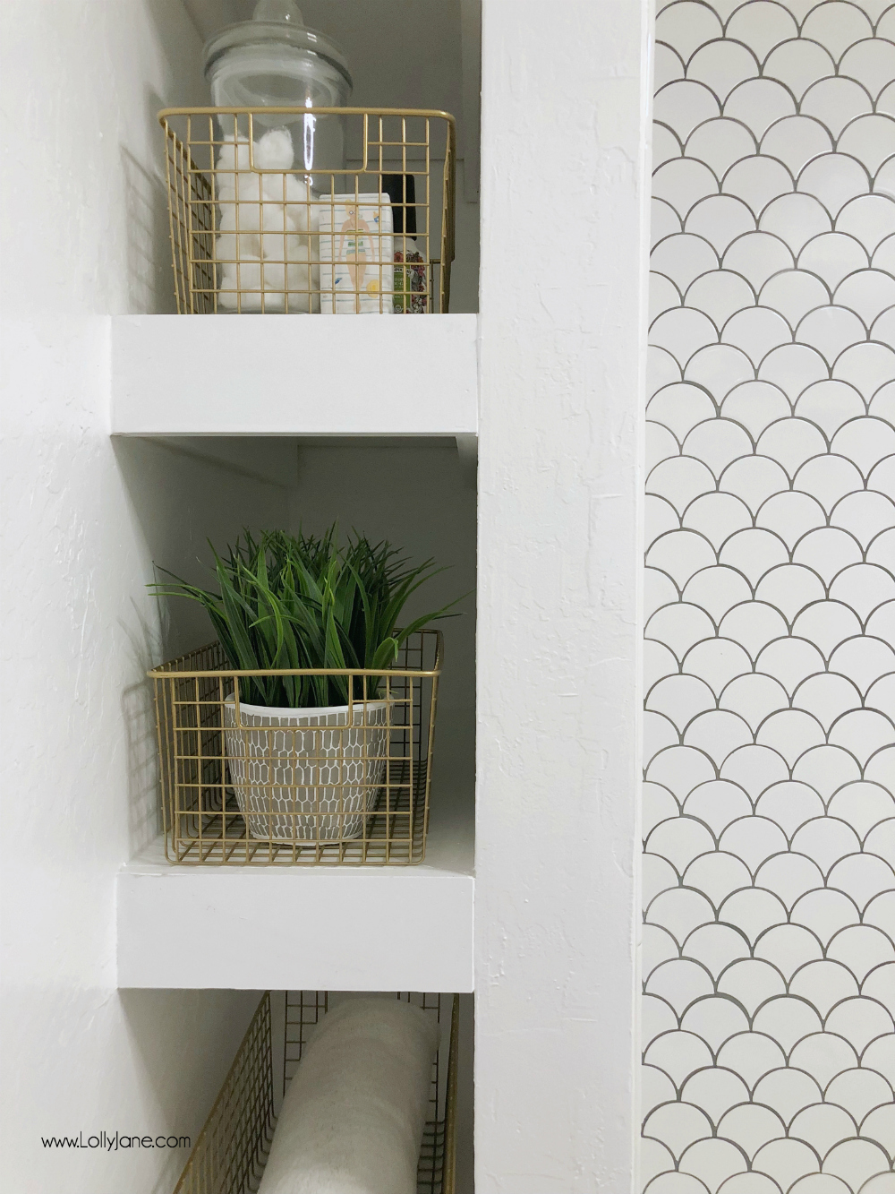 Can't decide if the DIY spray painted gold baskets are cuter OR the amazing built-in bathroom storage shelving... a FAB glam farmhouse bathroom makeover!