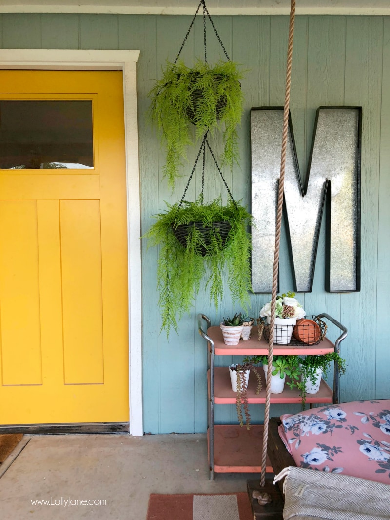 Tips for decorating with hanging plants on a porch. We love ferns and the color and texture they provide when decorating a back porch!