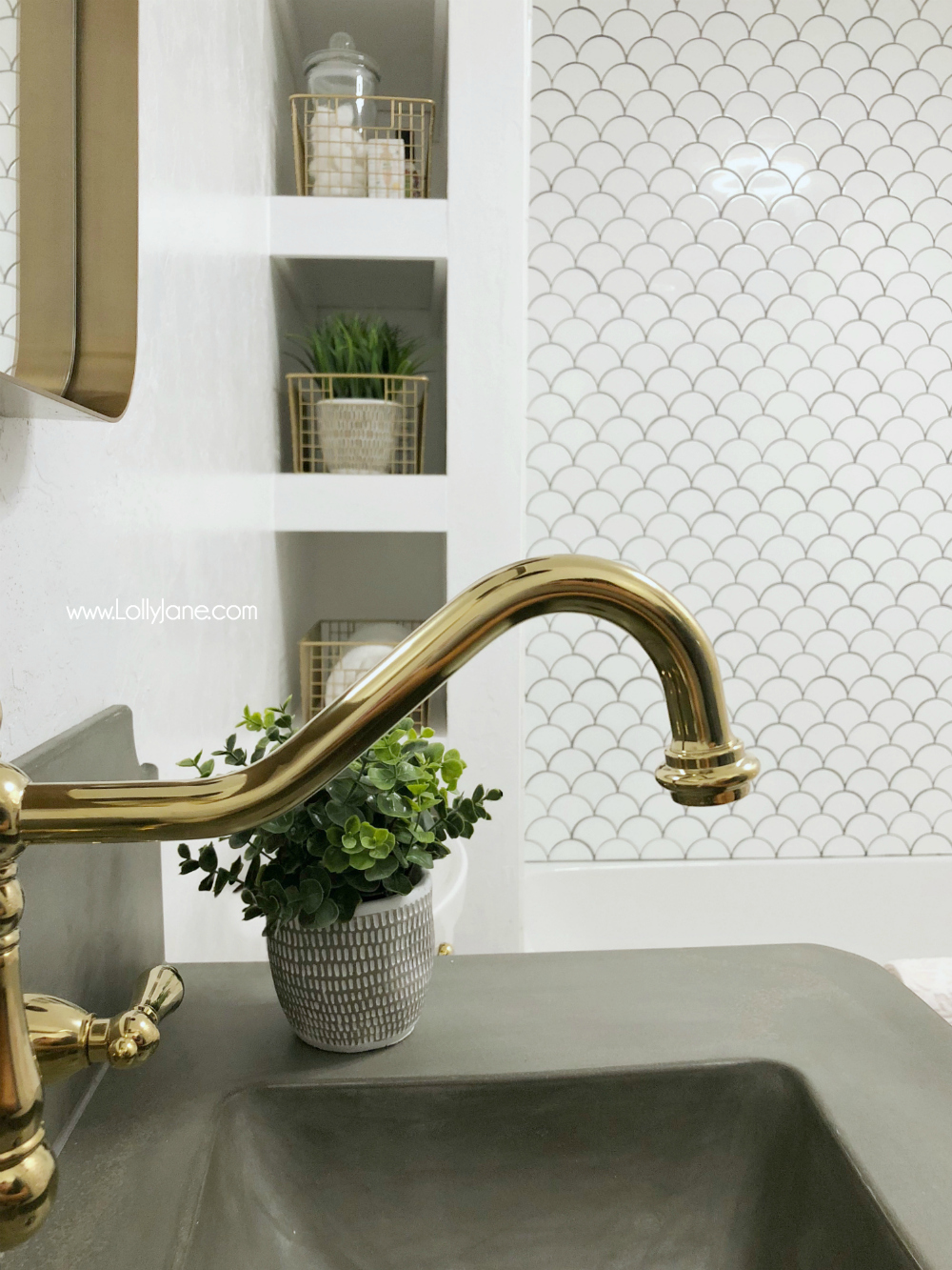 Sophisticated renovated farmhouse bathroom with pops of gold and bronze. Love this reveal!