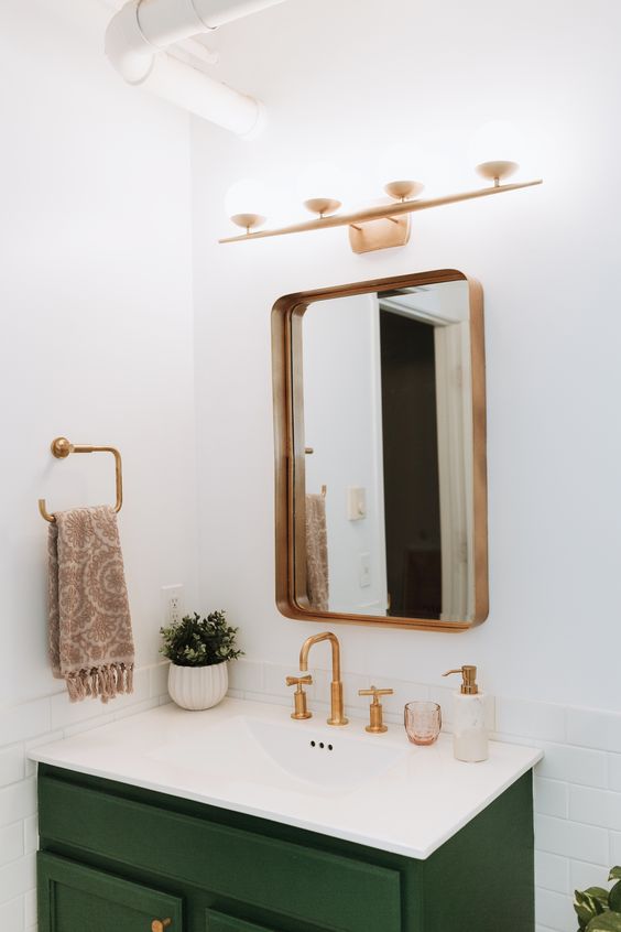 Adore this gold mirror with dark green vanity in this pretty modern bathroom remodel! Such pretty bathroom decor ideas!