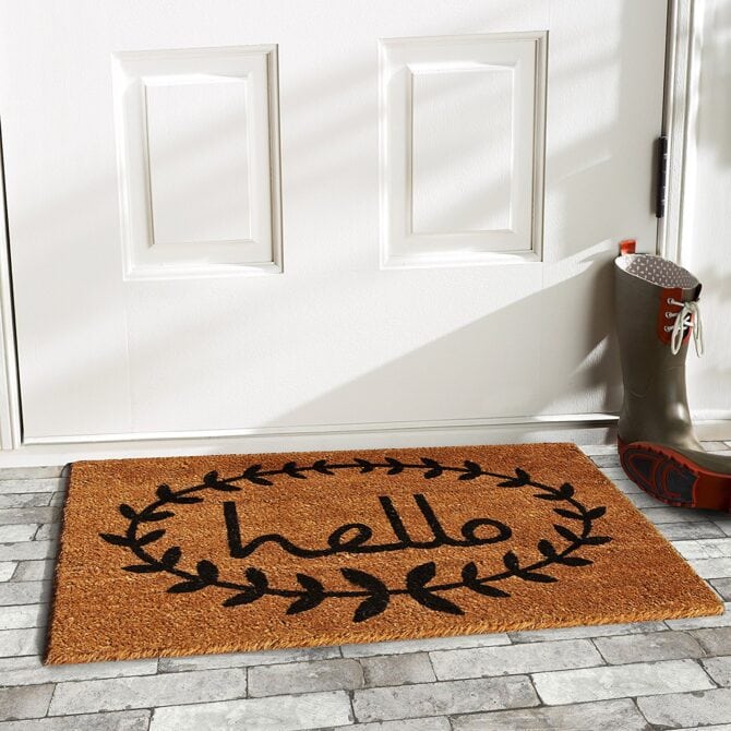 Love this hello rug with a laurel around it! Such a cute front door rug, especially layered with a buffalo check rug underneath!