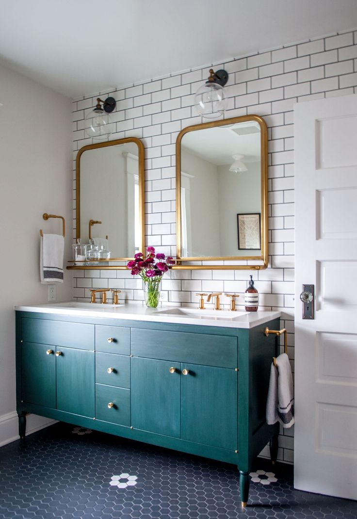 Love this turquoise bathroom vanity with gold rim mirrors in this bathroom remodel! Such a pretty bathroom with the subway tile and dark grout!