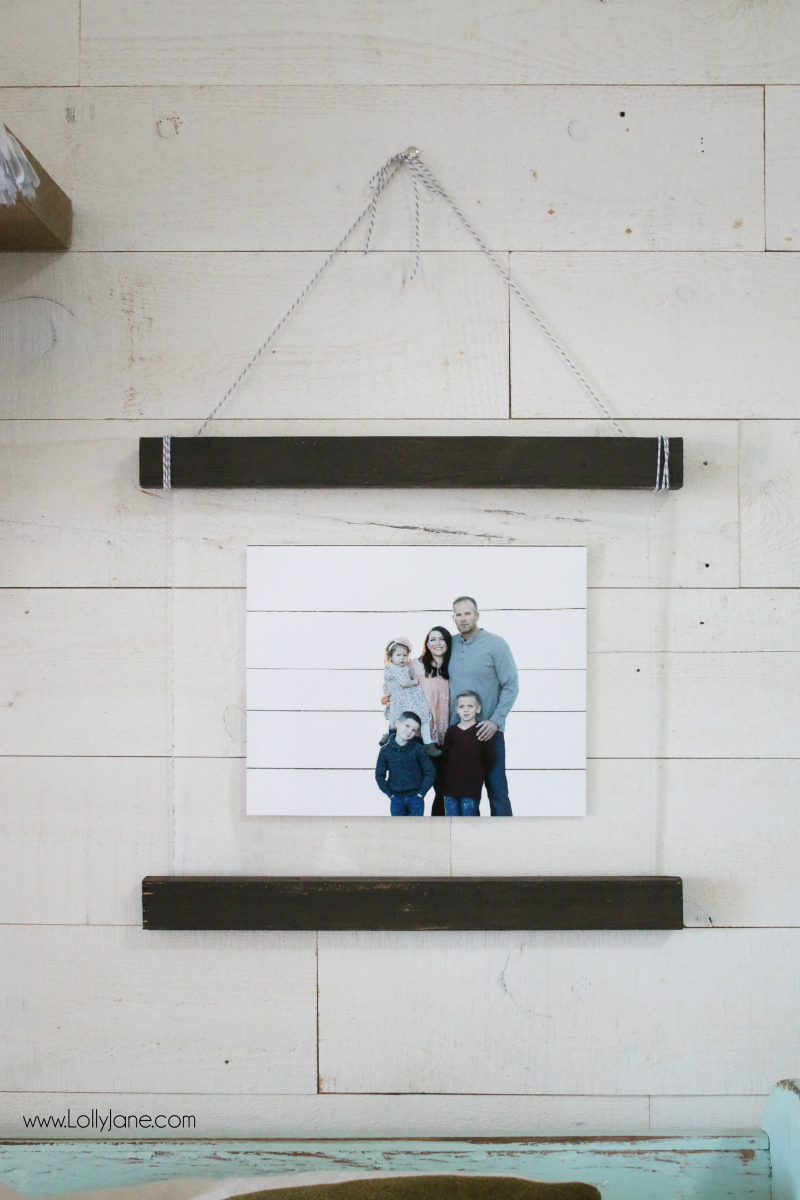 Love this easy to make diy acrylic scroll wall hanging. Such a fun way to display pictures! Love the use of plexiglass + wood, cute wall decor! #diy #shiplap #woodscroll #walldecor #pictureframetutorial