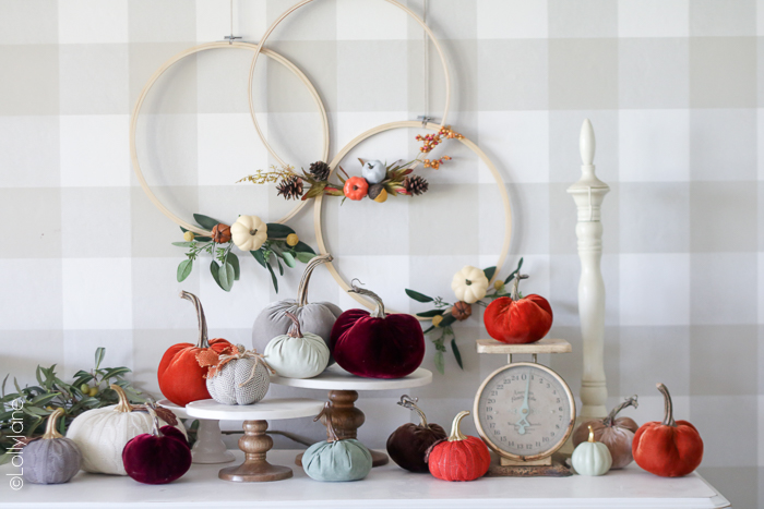This Easy Fall Wreath is made from an embroidery hoop, faux pumpkins + acorns, and in no time! For less than $15 and under 10 minutes, go make your own to welcome your autumn visitors!