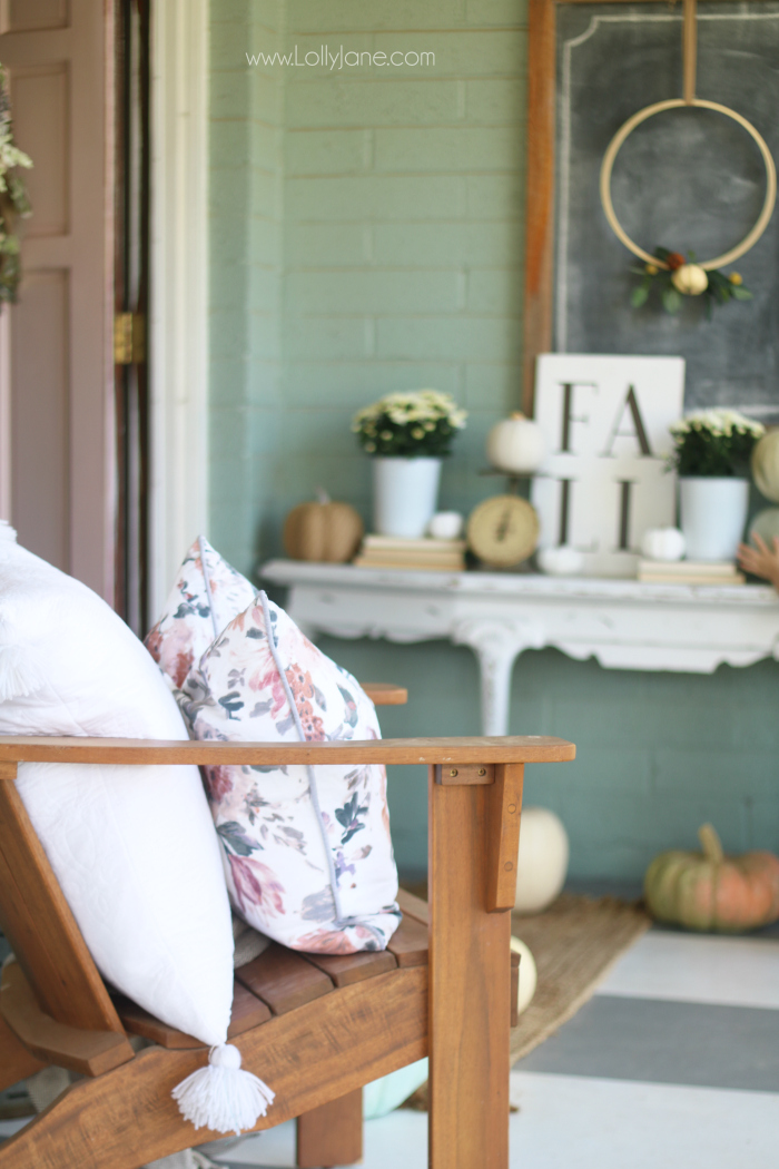 Tips for decorating for fall on a budget: place fresh mums in old buckets, stack fresh pumpkins on an outdoor table then layer in faux pumpkins to fill your outdoor porch decor. #falldecor #outdoorfalldecor #fallbudgetdecor #howtodecorateforfall