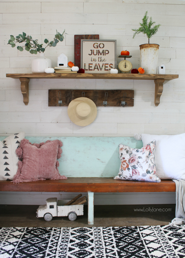 Easy fall mantel decor ideas. Love this simple fall sign paired with velvet pumpkins and eucalyptus leaves in a white vase with an olive bucket and topiary, too! Easy ways to decorate for fall to make your home cozy for the fall season. #falldecor #fallmantel #fammmanteldecor #falldecorations #fall #fallentryway