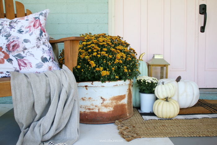 How to decorate with mums for fall. Add them into old buckets and olive buckets for easy fall porch decor. #falldecor #porchdecor #fallporchdecor #howtodecorateporchforfall