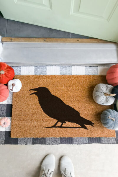 Welcome your spooky guests or trick-or-treaters with this EASY DIY Halloween Doormat... use a few supplies + minutes and transform a blank doormat into a fun piece of Halloween decor! Click picture for the full tutorial at LollyJane.com! #diy #halloweendecor #diydoormat #halloweendecor #crow #halloweendiy