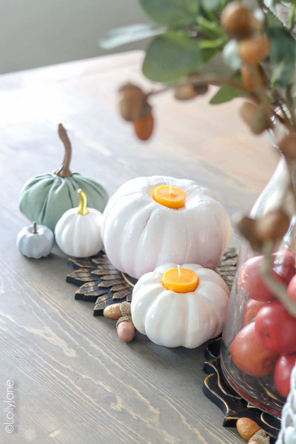 Plop a candle from the dollar store into a painted dollar store pumpkin to add some ambience and class to your fall table! Total cost, $2, wow!! CLICK to see other dollar store fall crafts! #diy #easytutorials #fallcrafts #falldecor