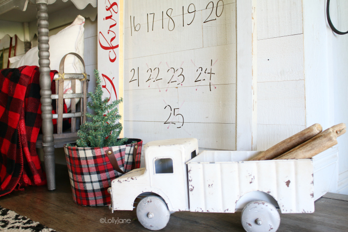 Such a fun Christmas countdown idea using an old window pane and dry erase markers! Love the boxwood wreath and old truck too! #easydecorations #christmasdecor #christmascountdown #countdowntochristmas