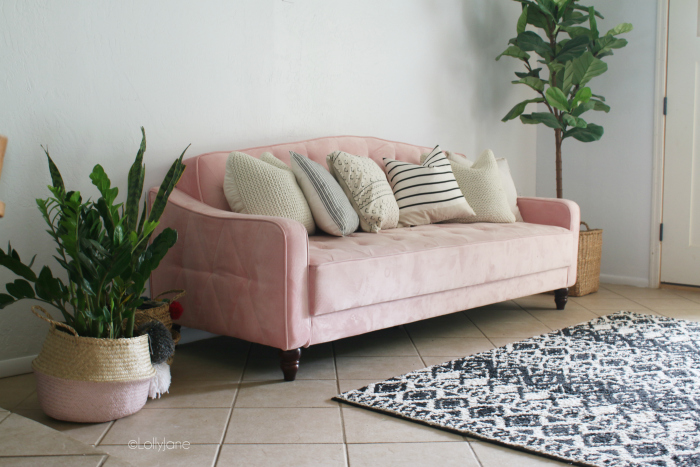 Remodeling a mid century modern living room starts with a fun pink tufted velvet couch and black and white accent pieces! #midcenturydecor #howtodecoratemidcentury #midcenturystyle