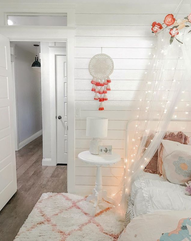Add twinkle lights to a canopy for a soft hue to a little girls bedroom! #twinklelights #fairylights #girlsroom