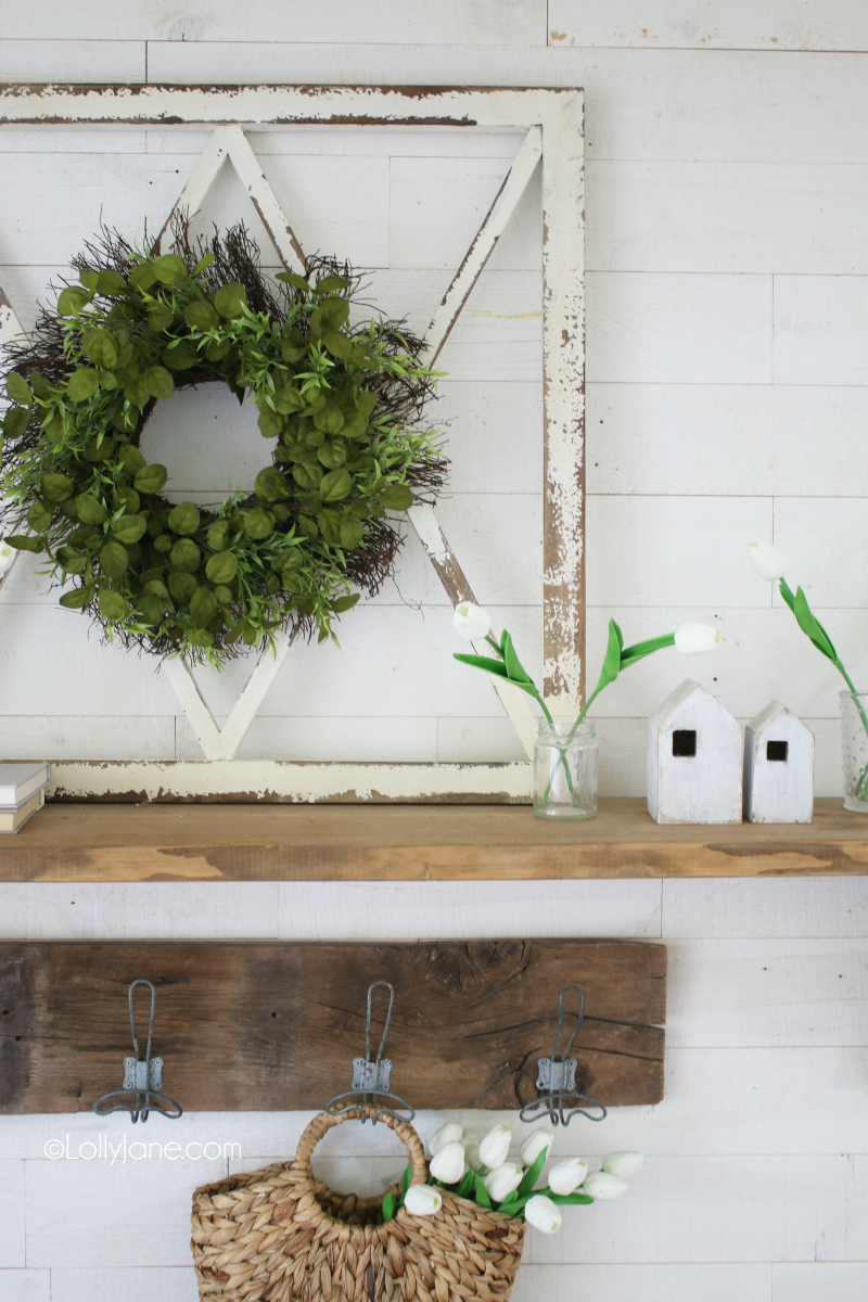 Love this fresh spring mantel decor with lots of natural pieces. Decorating with tulips is an easy way to welcome spring into your home! #tulips #springdecor #springdecorations #tulipdecor