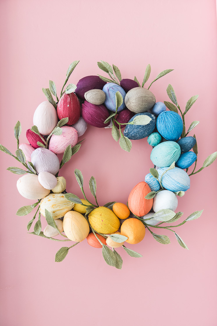 Love this easy to make rainbow egg wreath, ack! So cute!! Make this DIY crepe paper egg wreath with a few supplies and a lot of creativity! #eastercraft #springcraft #springdecor #springwreath