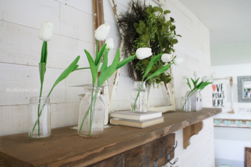 Love these artificial tulips to create easy spring mantle decorations. Adore the old window with a green wreath and old books. #easydecor #springmantel #tulips #decoratingwithtulips #springdecorations