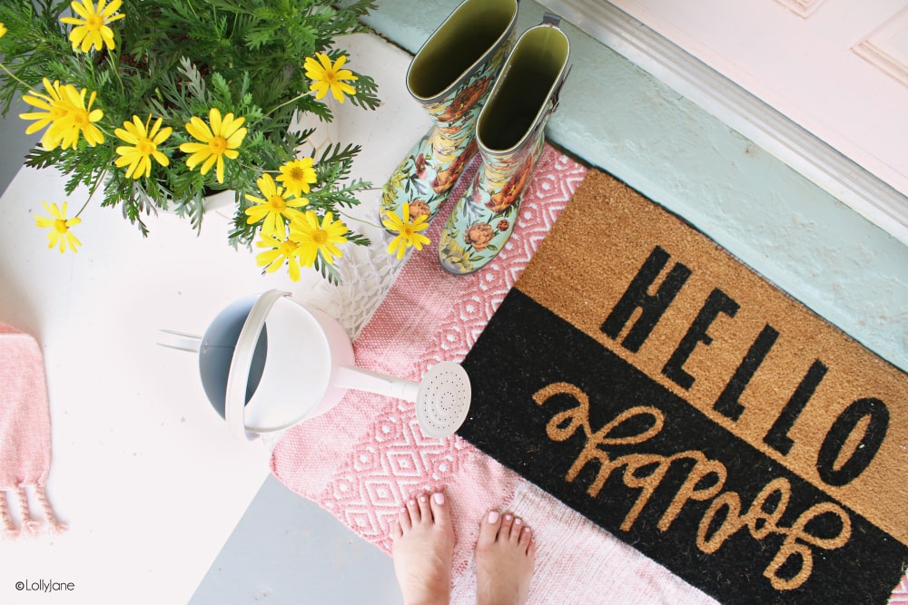 Your doormat is an easy way to welcome the season into your home and greet guests... pair it with a fun color to really show off what time of year it is! LOVE these EASY tips how to refresh your own porch, spring style! #diy #spring #springporch #welcomemat #florals