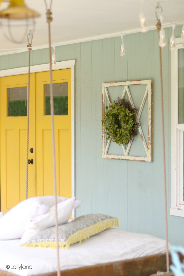 Have you seen these backyard porch lights?! They provide colorful ambiance for a fun farmhouse porch. So cute and practical! #carelights #porchliving #outdoorliving #farmhouseporch