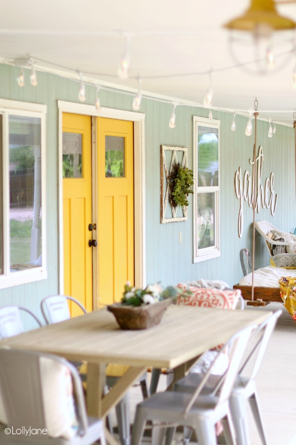 Looking for a cozy backyard with string lights? This cute patio features a modern farmhouse style porch, so cute! #farmhouseliving #cafelights #cozyporch #porchdecor #backporchliving