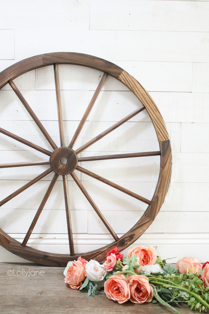 All the simple supplies to make a wagon wheel wreath. Easy to make summer wreath decoration, so fun! #wagonwheelwreath #diywreath #summerdecorations #summerdecor #howto